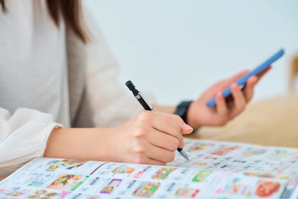A woman reading a booklet and making notes